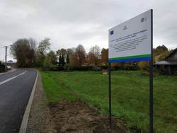 zdjęcie przedstawia tablicę promocyjną dotyczącą unijnego dofinansowania przebudowy ulic Skoczowskiej i Stary Dwór w Górkach Wielkich